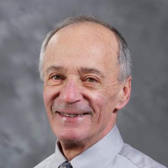 A headshot shows a former member of the MBARI Board of Directors with gray hair wearing a gray shirt and tie. The background is a textured gray screen.